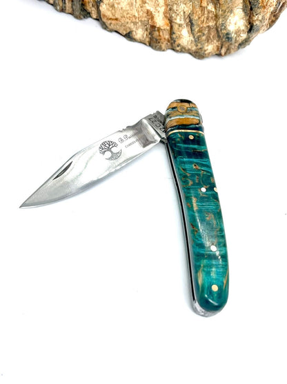 Coutellerie Passarelli - Couteau Alsacien lame pliable 10 cm mitre en molaire de mammouth, Bouleau madré teinté (turquoise) et stabilisé